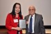 Dr. Nagib Callaos, General Chair, giving Dr. Yaping Gao a plaque "In Appreciation for Delivering a Great Keynote Address at a Plenary Session."